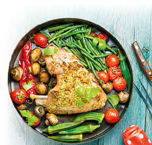 Roasted turkey with grilled vegetables on wooden table