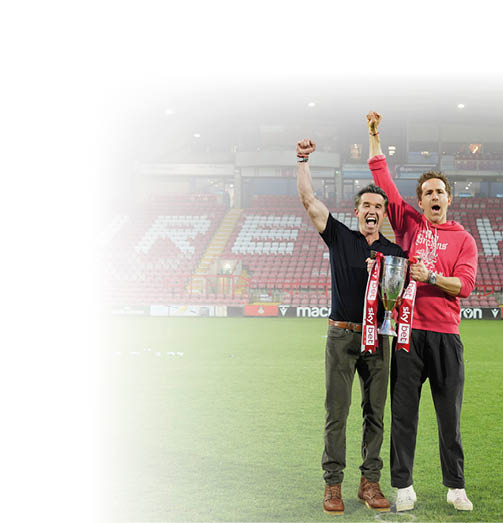Wrexham co-owners Rob McElhenney, left, and Ryan Reynolds pose with trophy at the end of the English League One soccer match between Wrexham and Charlton Athletic at the Racecourse ground in Wrexham, Wales, Saturday, April 26, 2025. (AP Photo/Jon Super)