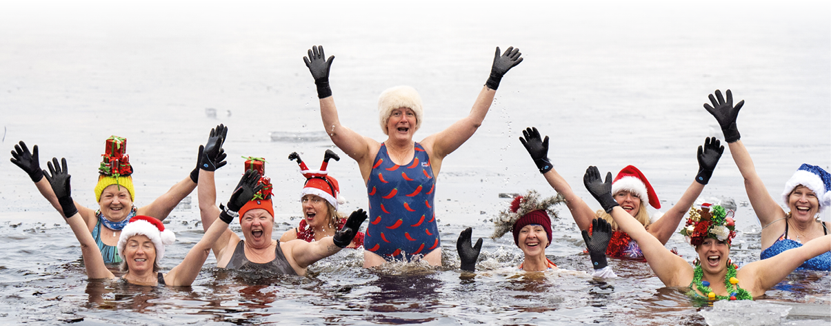 Loch Insh Festive ice swim. Members of the Loch Insh Dippers wild swim group take part in a Christmas-themed swim in the frozen Loch Insh, Kingussie, in the Cairngorms National Park. Picture date: Friday December 13, 2024. Photo credit should read: Jane Barlow/PA Wire URN:78474364