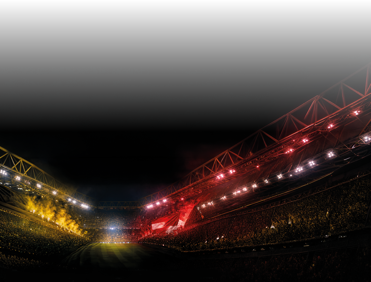 Ein gro es, beleuchtetes Stadion mit vielen Zuschauern und einer Mischung aus gelben und roten Lichtern auf den Trib nen bei Nacht. Beschreibung von KI generiert
